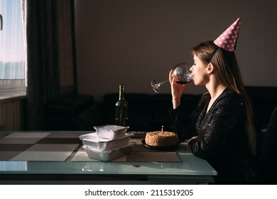 Young Woman Drinking Wine At The Table, Birthday Party At Home Alone, Sadness And Loneliness, Self-isolation On Holiday, Profile View, Alcohol And Lifestyle Concept