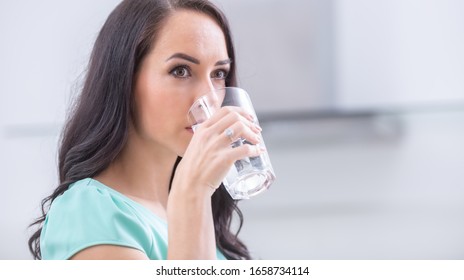 Young Woman Drinks Clean Water Adheres To Drinking Regime.