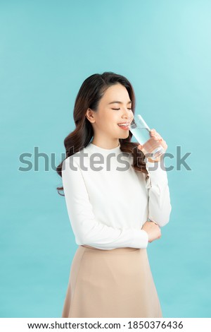 young woman drinks clean water adheres to drinking regime.