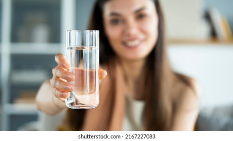 Young woman drinks a glass of water - Shutterstock ID 2167227083