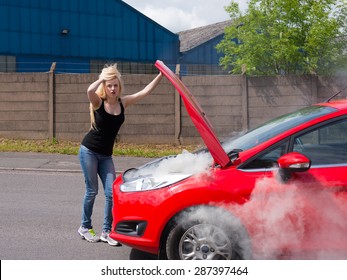 Young Woman Driver With Car Fire Breakdown