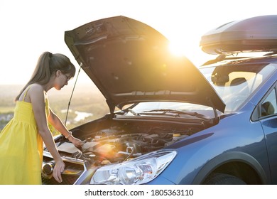 Young Woman Driver Standing Near Her Car With Open Hood Having Motor Problem.