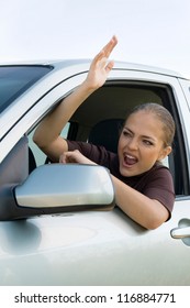 Young Woman Driver Yelling Out Car Window.