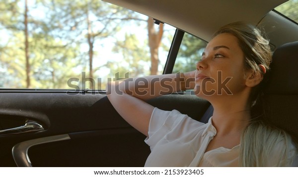 The young woman is driving around on vacation.\
She looks around happily and seems to have enjoyed it. She relaxed\
and found peace.\
