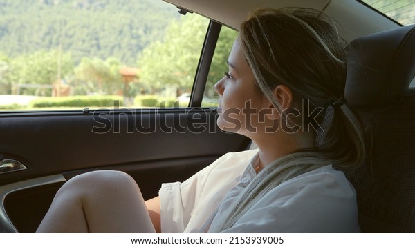 Young woman driving around and watching.Young\
woman looking calmed and\
peaceful.\
