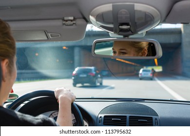 Young Woman Driving By Car On The Autobahn, View From Inside The Auto