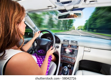 Young Woman Driving Car. Fast Motion Effect.