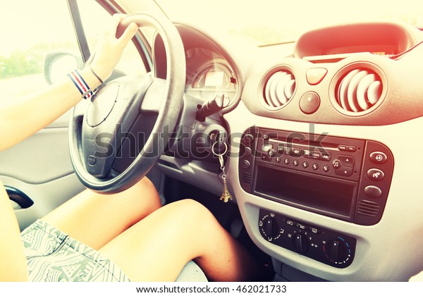 Young Woman is\
Driving a Car. Vintage\
filter