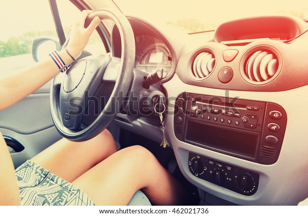 Young Woman is\
Driving a Car. Vintage\
filter
