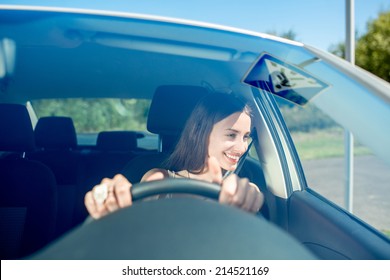 Young Woman Driving Car. Windshield View