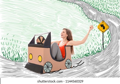 Young Woman Driving Cardboard Auto On Imaginary Road. Dreaming Of Car