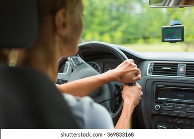 Young Woman Driving Her Car, On Her Way Home From Work - Doing The Daily Commute