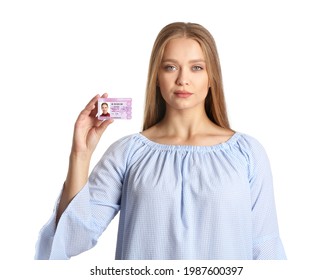 Young woman with driving license on white background