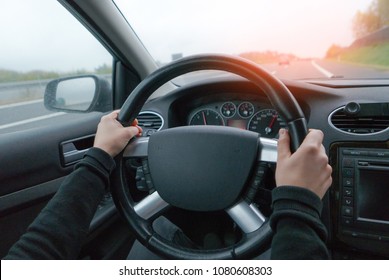 Young woman driving in modern car
