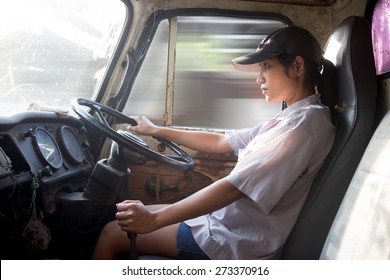 Young Woman Driving A Truck. A Look Inside The Truck On The Female Drivers. Speeding Old Used Lorry Driving Asian Women. Interior Of A Moving Truck With Driver. Freight Transport In Asia.