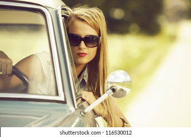 Young Woman Driving Vintage Car.