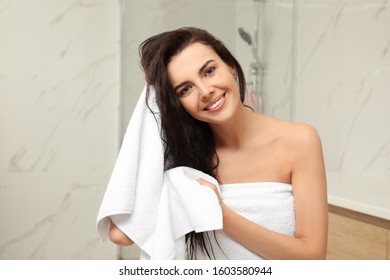 Young Woman Drying Hair With Towel In Bathroom