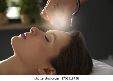 Young Woman During Crystal Healing Session In Therapy Room