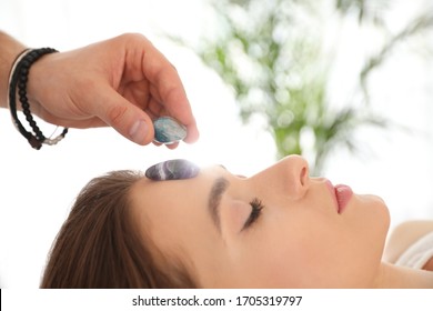 Young Woman During Crystal Healing Session In Therapy Room