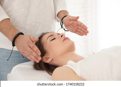 Young Woman During Crystal Healing Session In Therapy Room