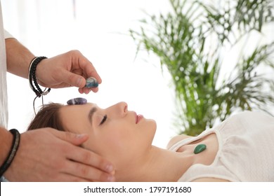 Young Woman During Crystal Healing Session In Therapy Room