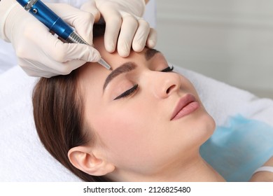 Young woman during procedure of permanent eyebrow makeup in beauty salon, closeup - Powered by Shutterstock