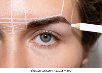 Young woman during professional eyebrow mapping procedure before permanent makeup - Shutterstock ID 2101674592