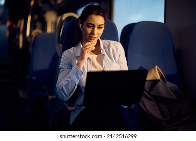 Young Woman Earing An E-mail While Commuting To Work By Train. 