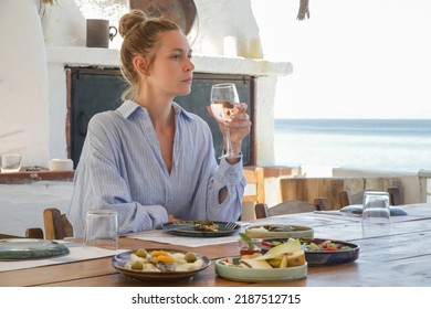 Young woman eating alone in the restaurant. Concept of solo dining in a casual restaurant. Eating out alone.