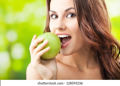 Young Woman Eating Apple, Outdoors