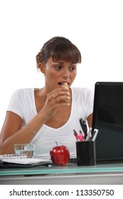 Young Woman Eating A Cereal Bar