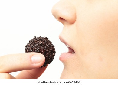 Young Woman Eating Chocolate Cookie