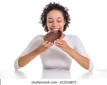 Young Woman Is Eating A Chocolate Easter Egg.