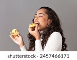 Young woman eating cookie. Woman with delicious cookie