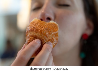 Young Woman Eating Croissant, Pleasure, Guilt Free Eating