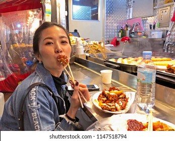 Young Woman Eating Crunchy Korean Fried Chicken Street Food In Seoul, South Korea