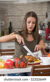 Young Woman Eating Dinner In Her Kitchen At Her Home