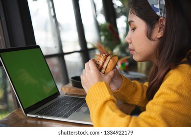 Young Woman Eating Fatty Hamburger.Craving Fast Food.Enjoying Guilty Pleasure, Eating Junk Food.Satisfied Expression.Breaking Diet Rules,giving Up Diet.Unhealthy Imbalanced Nutrition Calorie Intake.