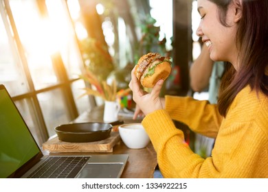 
Young Woman Eating Fatty Hamburger.Craving Fast Food.Enjoying Guilty Pleasure, Eating Junk Food.Satisfied Expression.Breaking Diet Rules,giving Up Diet.Unhealthy Imbalanced Nutrition Calorie Intake.
