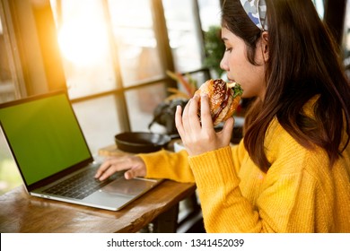 
Young Woman Eating Fatty Hamburger.Craving Fast Food.Enjoying Guilty Pleasure, Eating Junk Food.Satisfied Expression.Breaking Diet Rules,giving Up Diet.Unhealthy Imbalanced Nutrition Calorie Intake.
