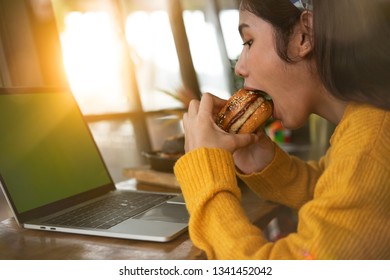 
Young Woman Eating Fatty Hamburger.Craving Fast Food.Enjoying Guilty Pleasure, Eating Junk Food.Satisfied Expression.Breaking Diet Rules,giving Up Diet.Unhealthy Imbalanced Nutrition Calorie Intake.
