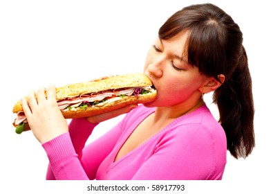 Young Woman Eating A Freshly Made Sub Sandwich Isolated On White