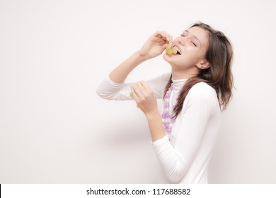 Young Woman Eating Grapes