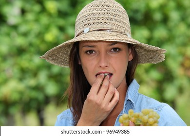 Young Woman Eating Grapes