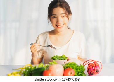 Young Woman Is Eating Green Vegetables For Weight Loss
