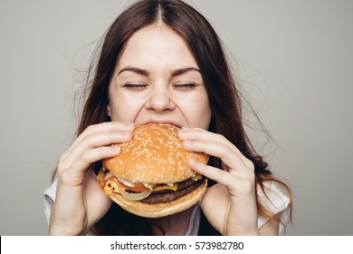 Young Woman Eating Hamburger Woman Eating Junk Food, Fatty Food Hamburger.