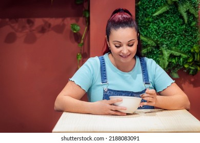 Young Woman Eating A Healthy Acai Smoothie Bowl. Healthy Eating Concept.