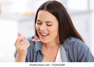 Young woman eating healthy breakfast, closeup