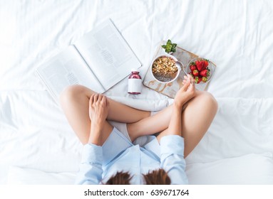 Young Woman Eating Healthy Breakfast In Bed 