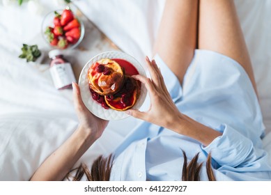 Young Woman Eating Healthy Breakfast In Bed 